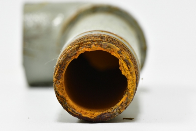 Deteriorated water pipe with red rust
