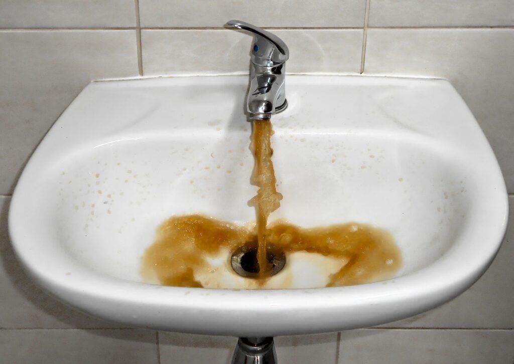 Image of red water coming out of a faucet
